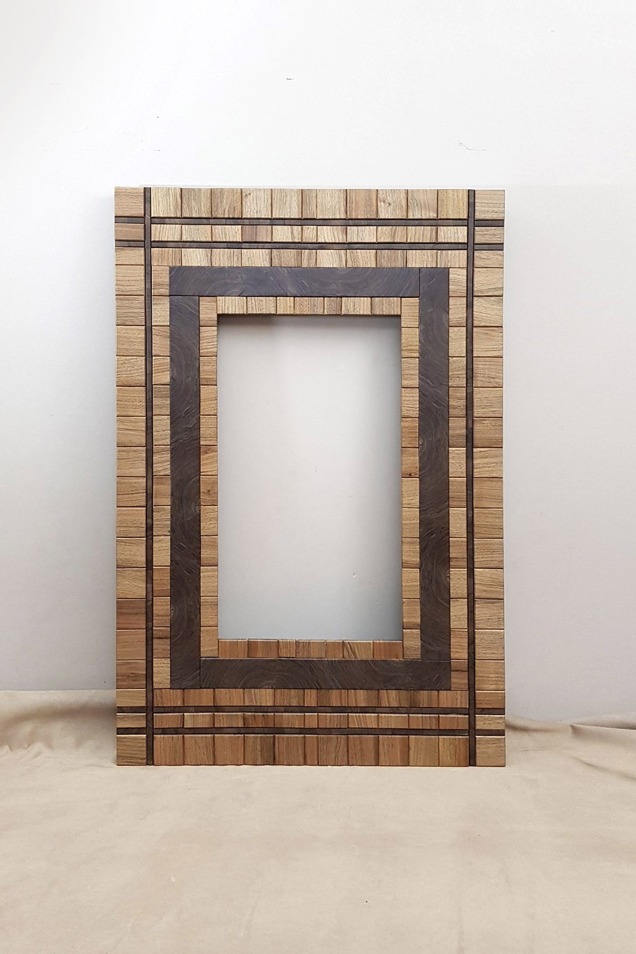 Centrepiece wall mount mirror frame in walnut