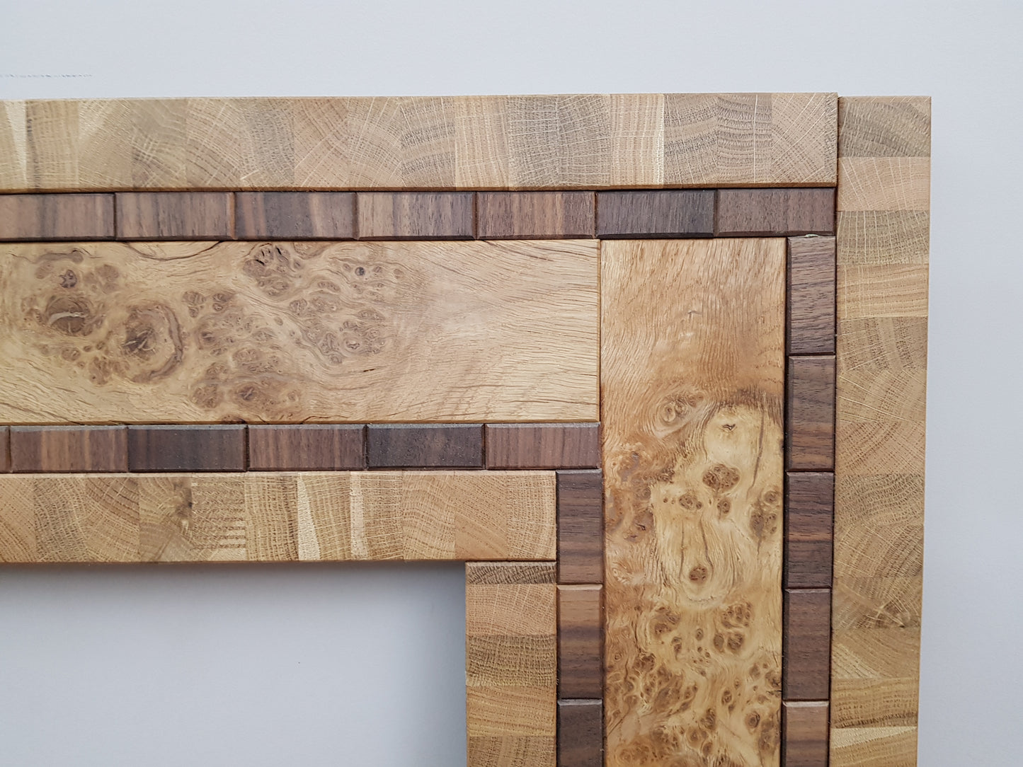 Centrepiece statement mirror frame in figured oak and walnut
