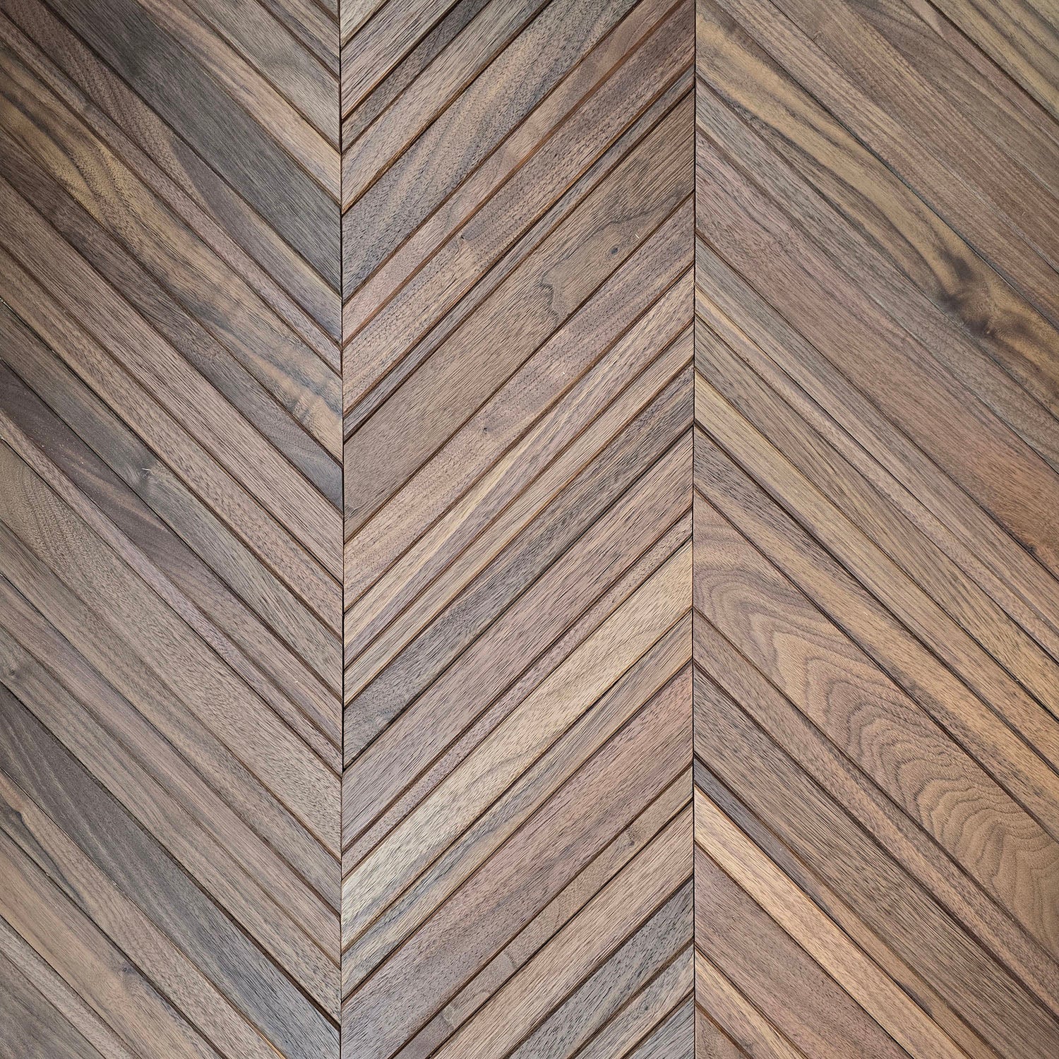 Wooden panel with a chevron pattern in walnut
