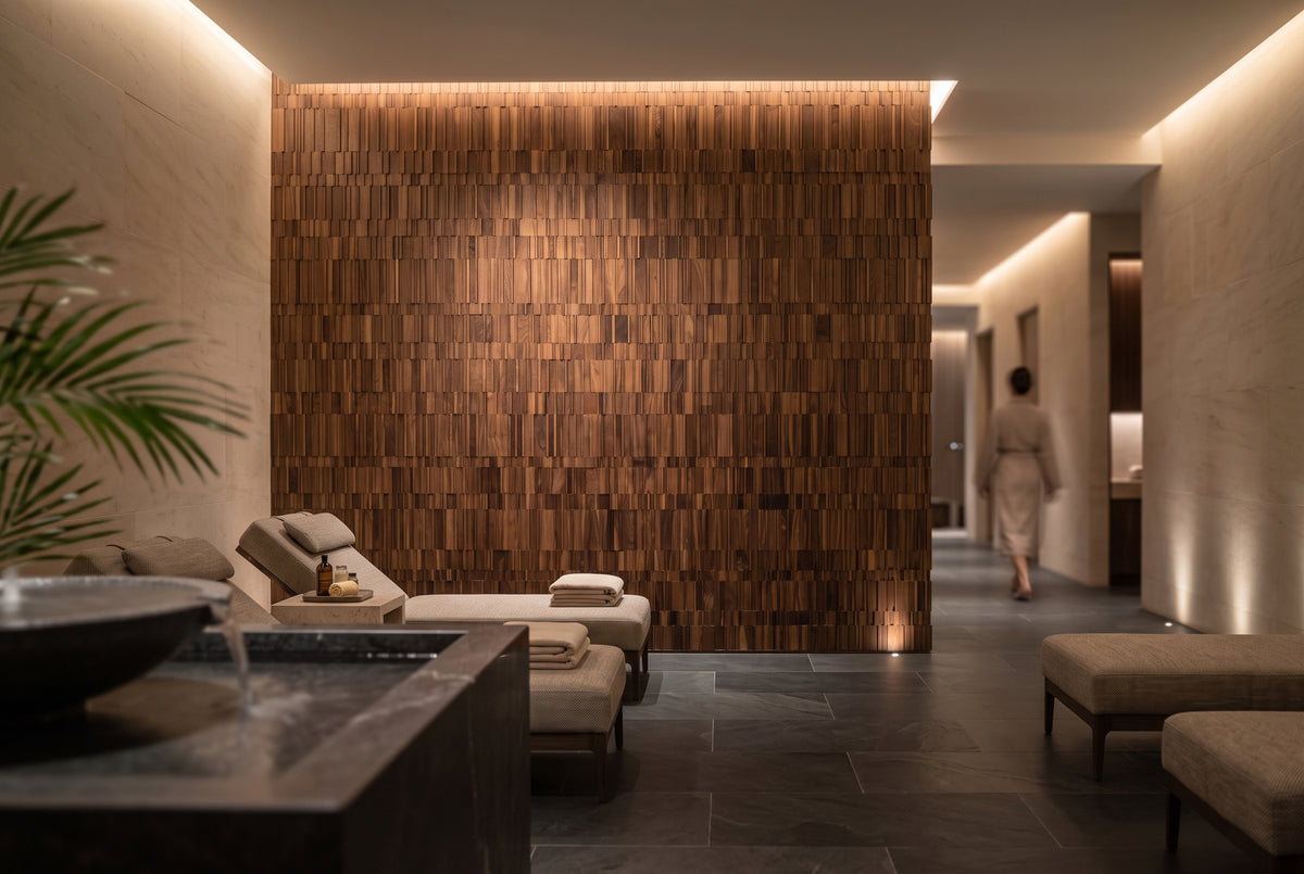 A modern spa interior with a large wooden slat wall, and warm ambient lighting. 