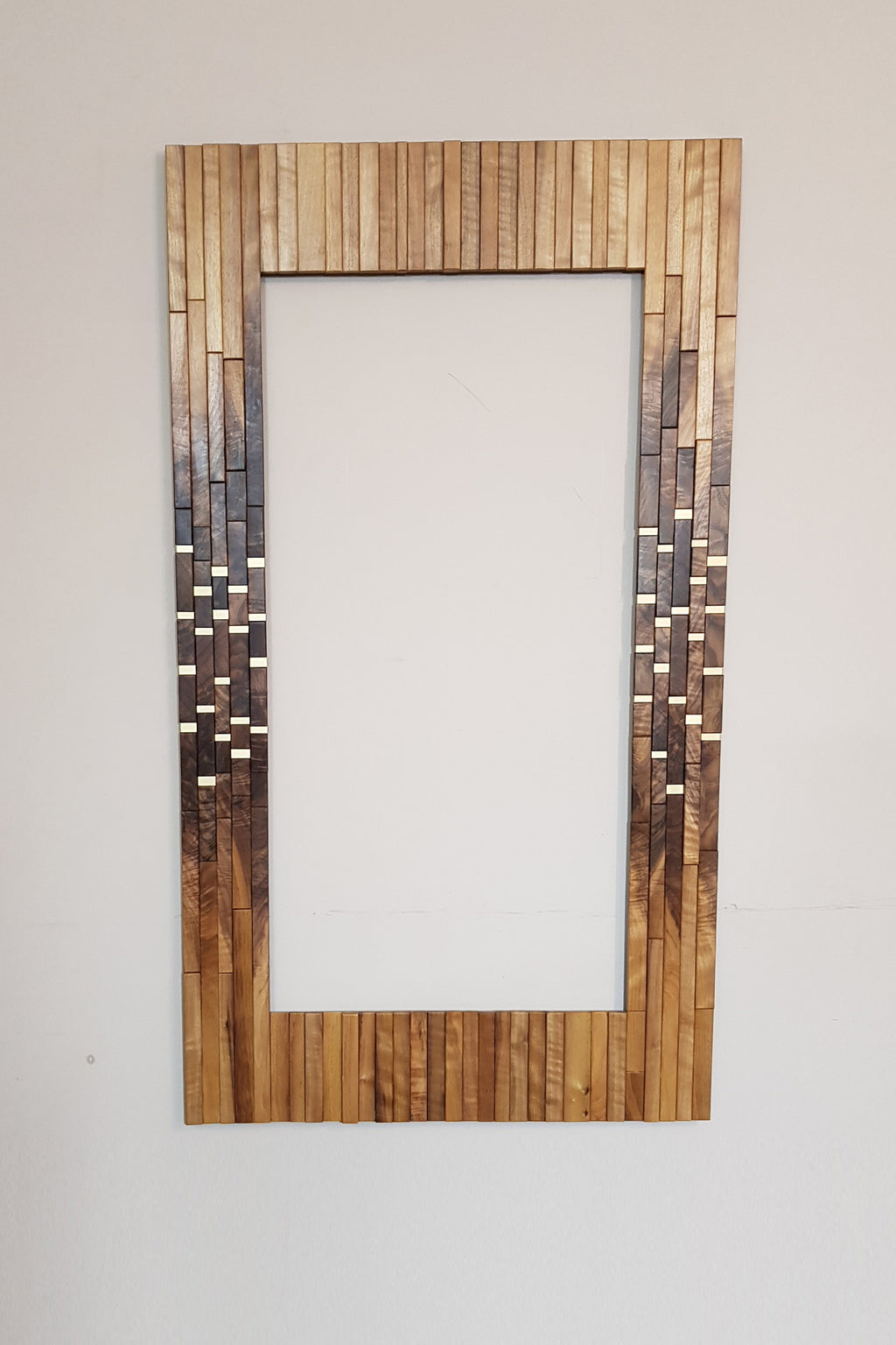 Modern centrepiece statement mirror frame in figured walnut and brass