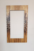 Modern centrepiece statement mirror frame in figured walnut and brass