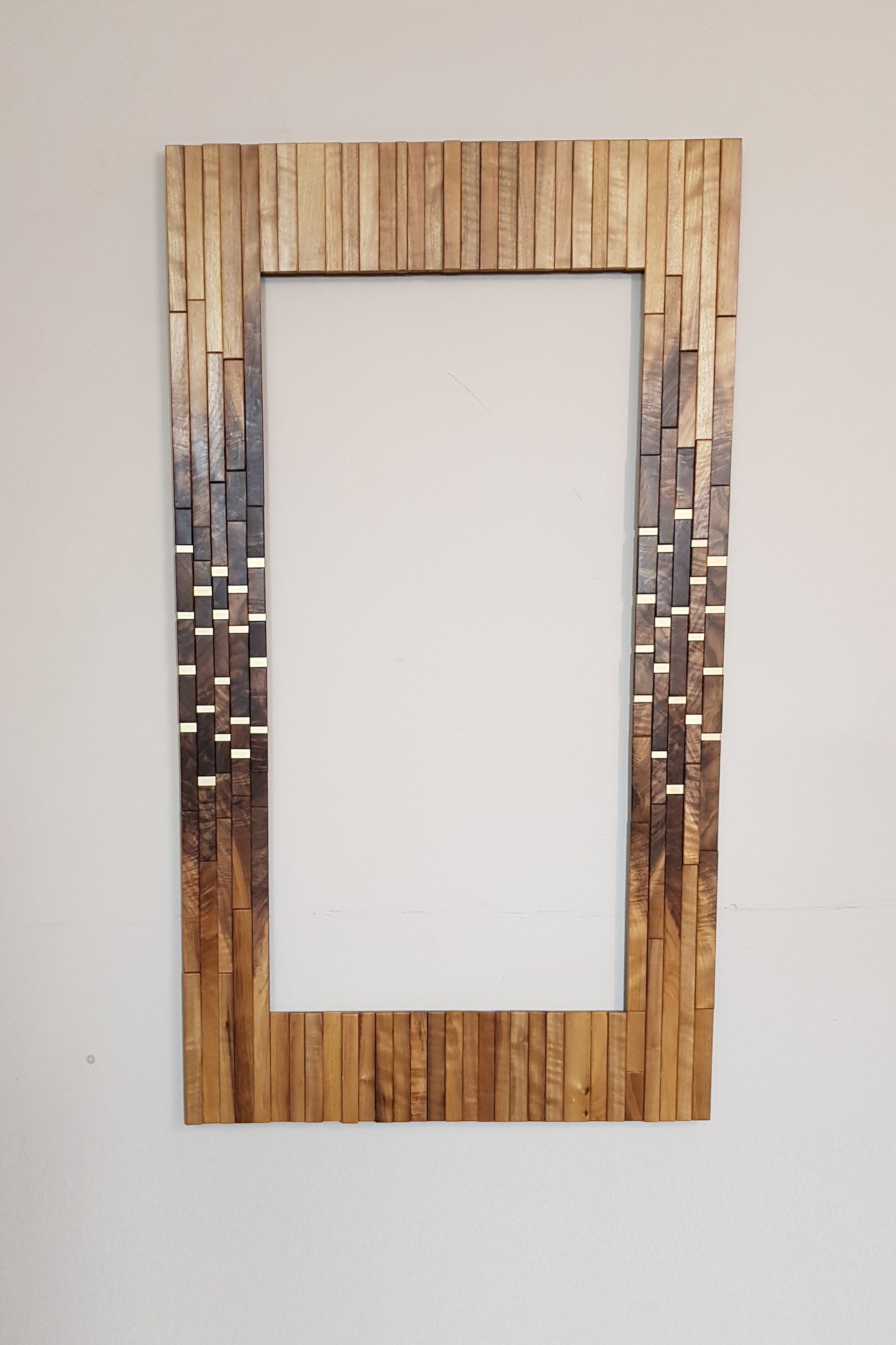 Modern centrepiece statement mirror frame in figured walnut and brass
