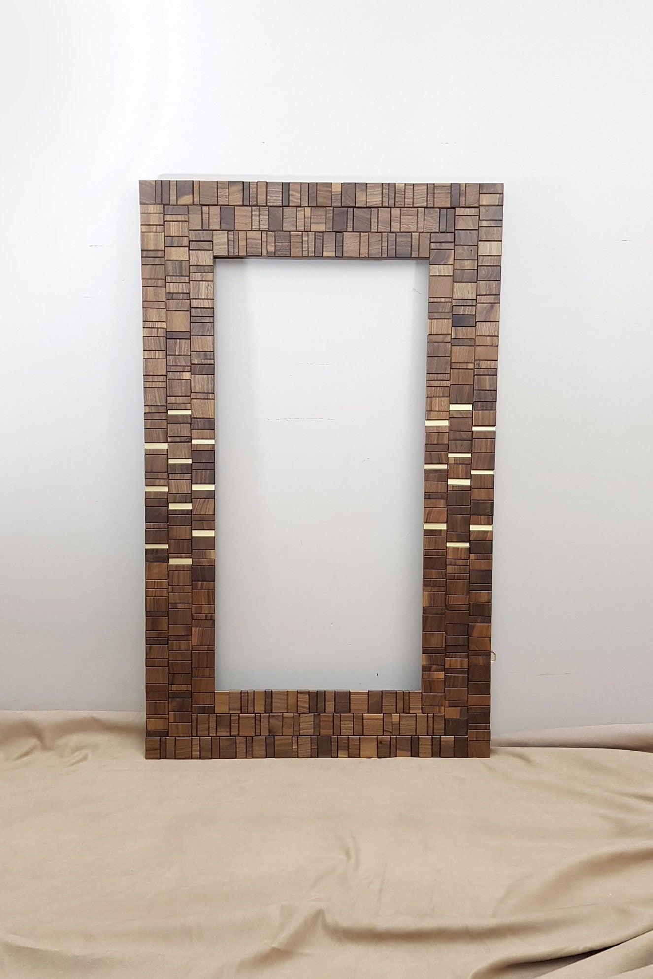 Walnut and brass mirror frame.