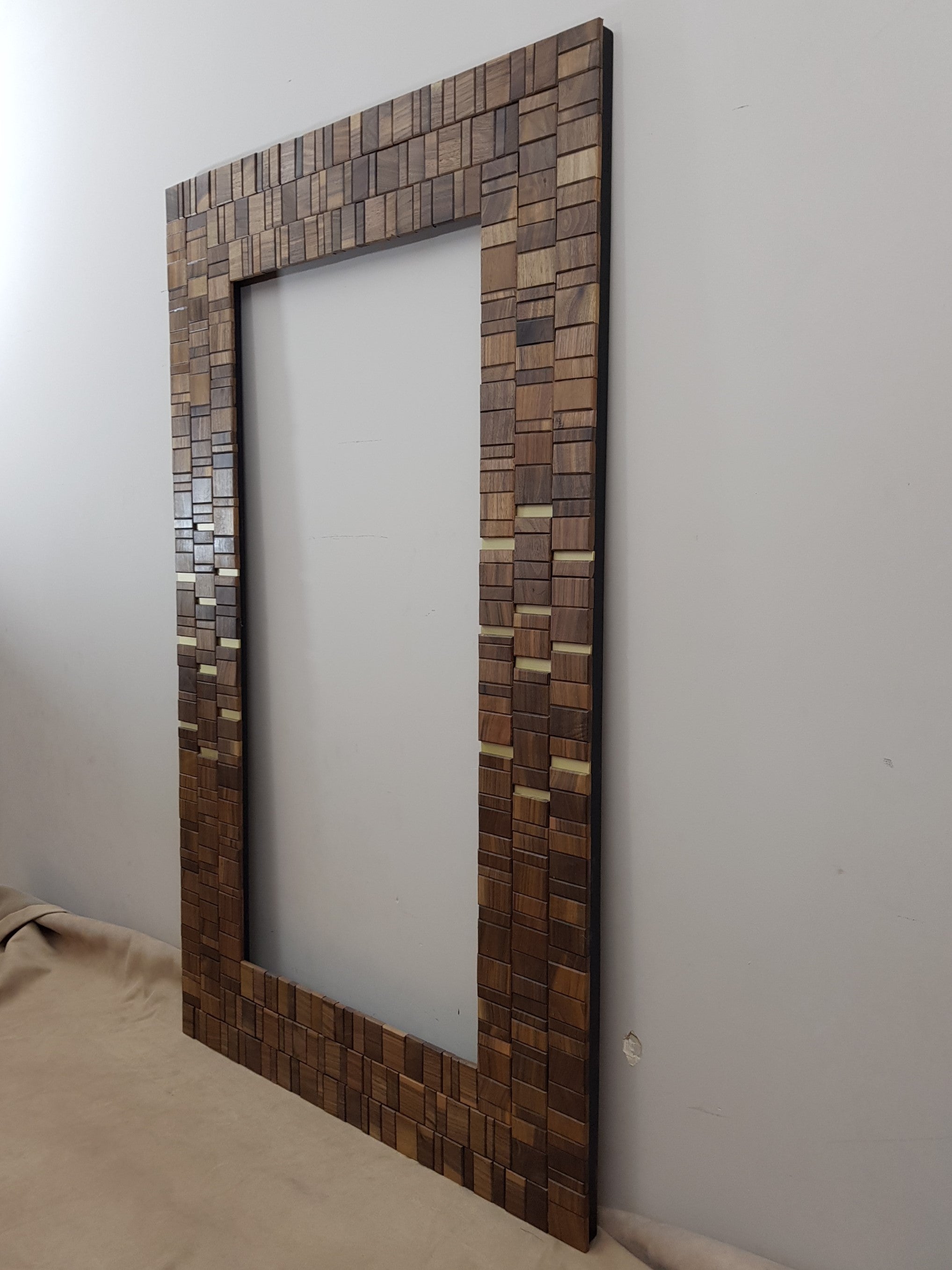 Walnut and brass mirror frame.