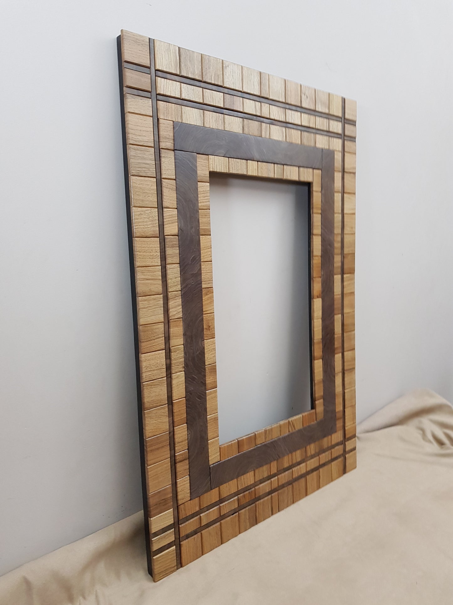 Centrepiece wall mount mirror frame in walnut