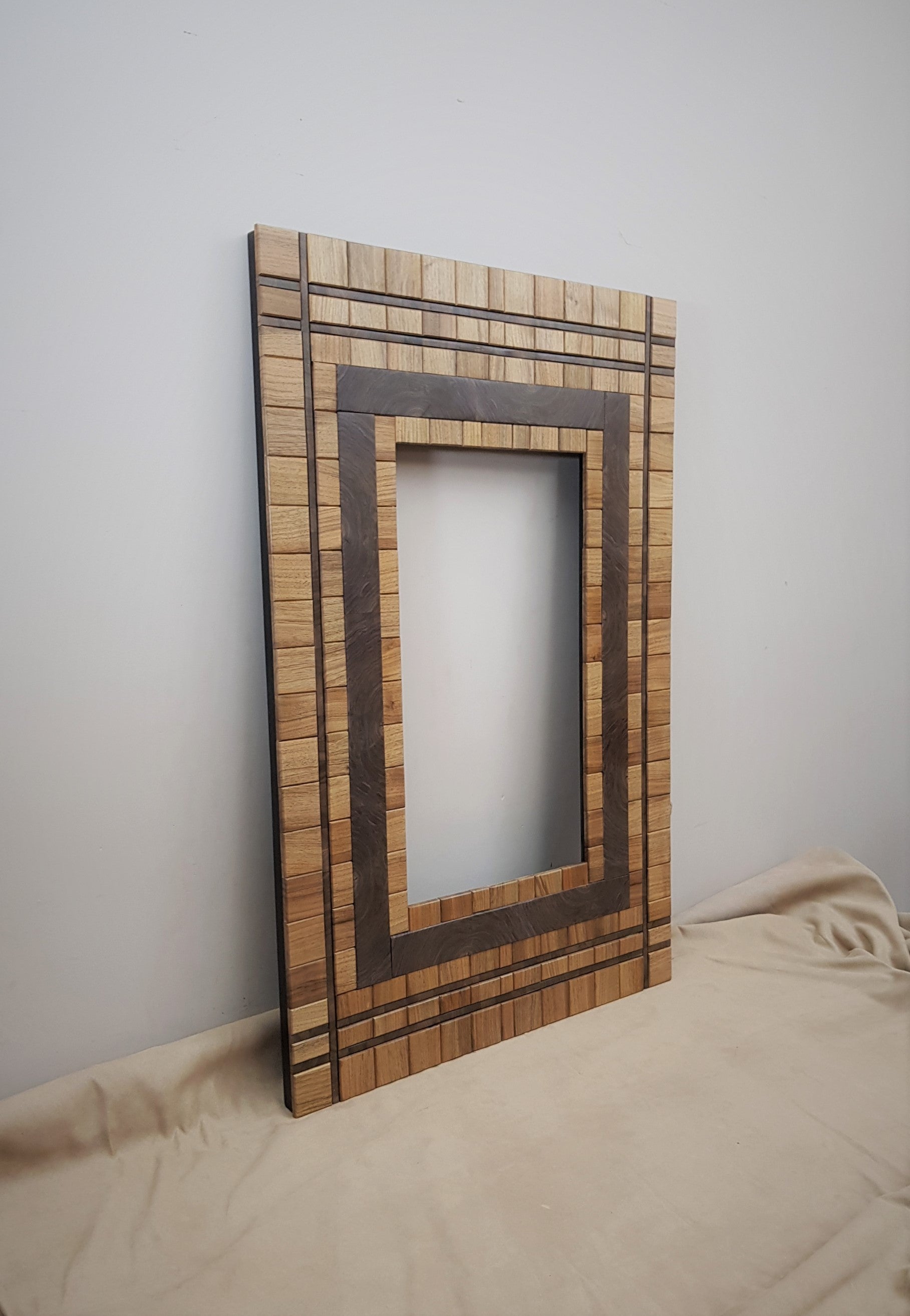 Centrepiece wall mount mirror frame in walnut