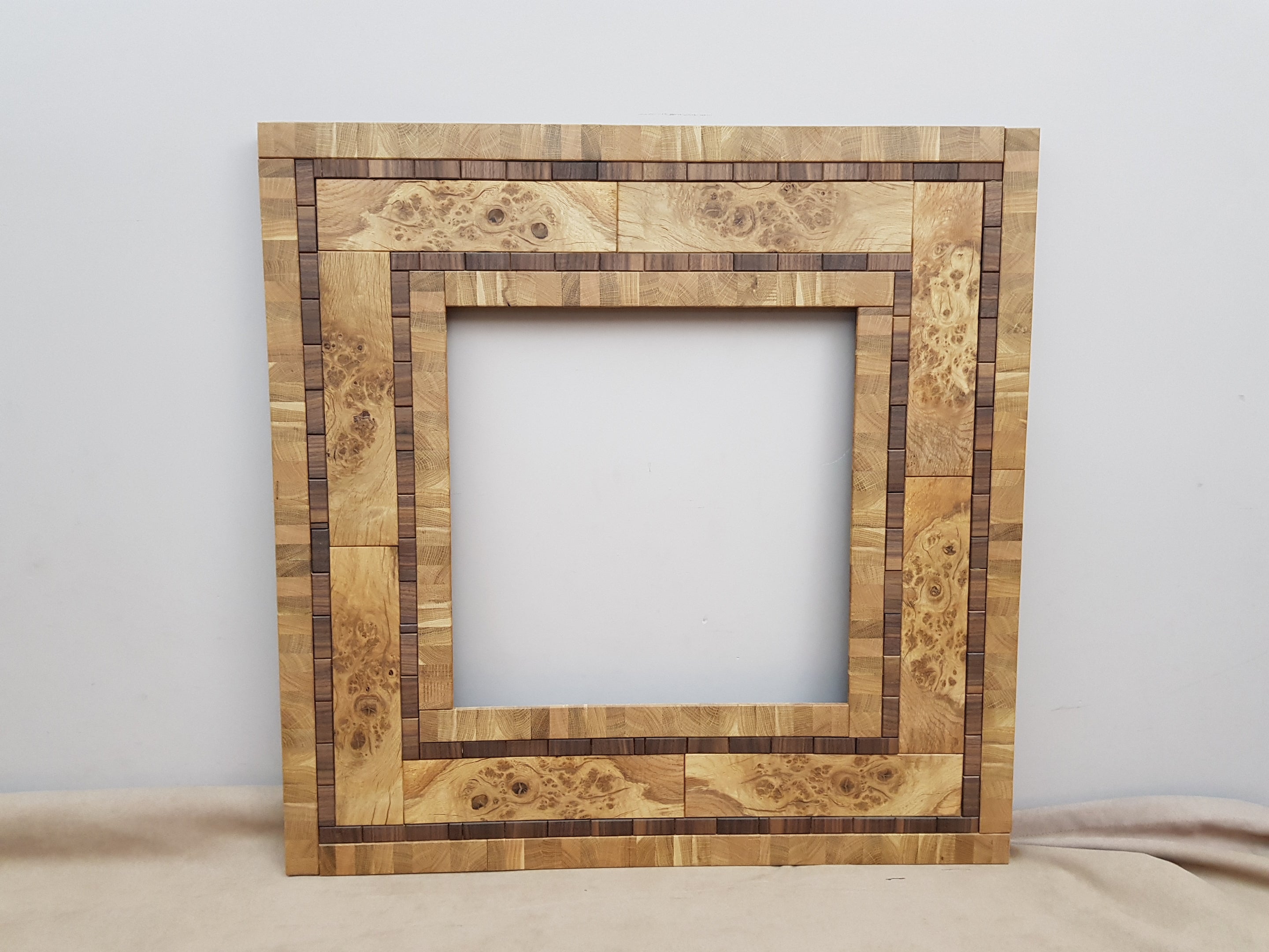 Centrepiece statement mirror frame in figured oak and walnut