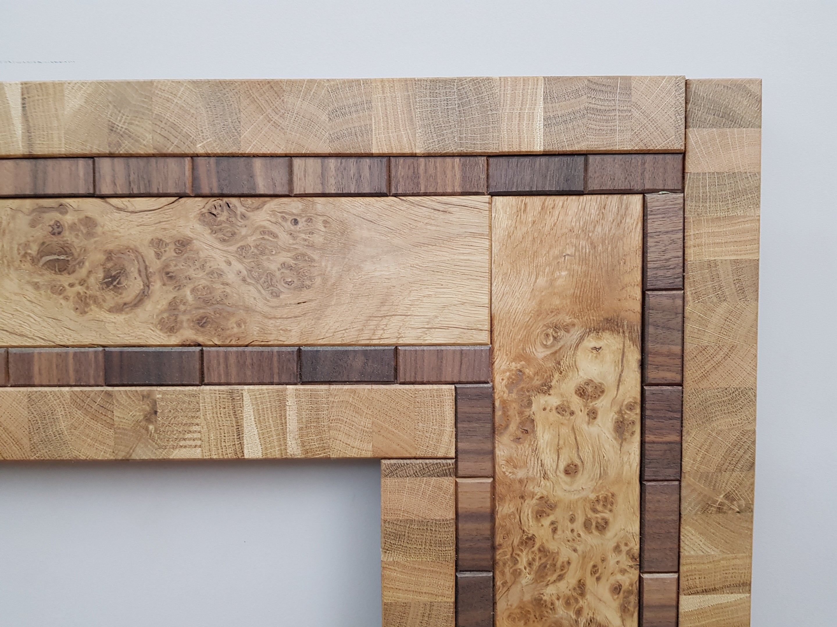 Centrepiece statement mirror frame in figured oak and walnut