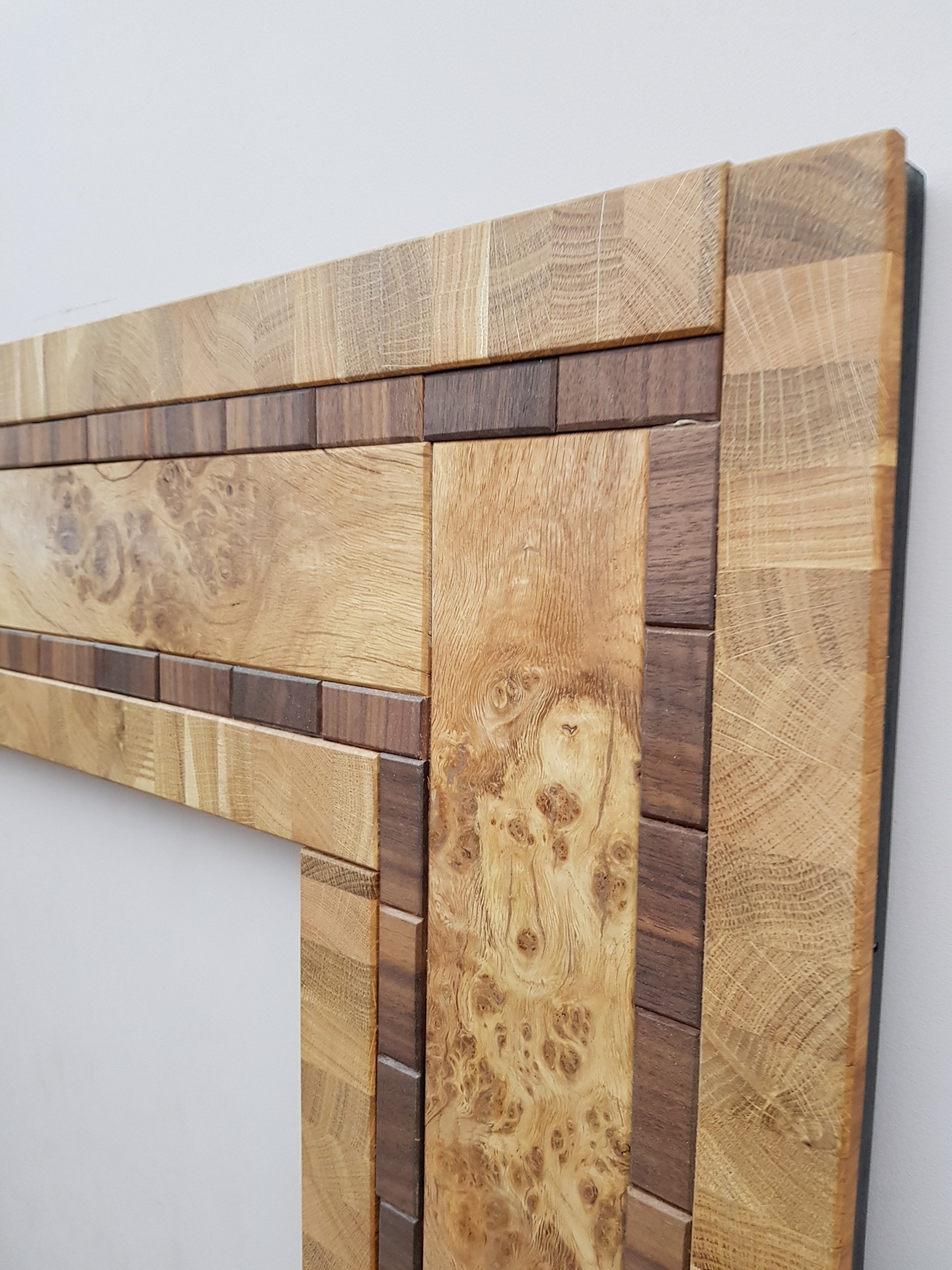 Centrepiece statement mirror frame in figured oak and walnut