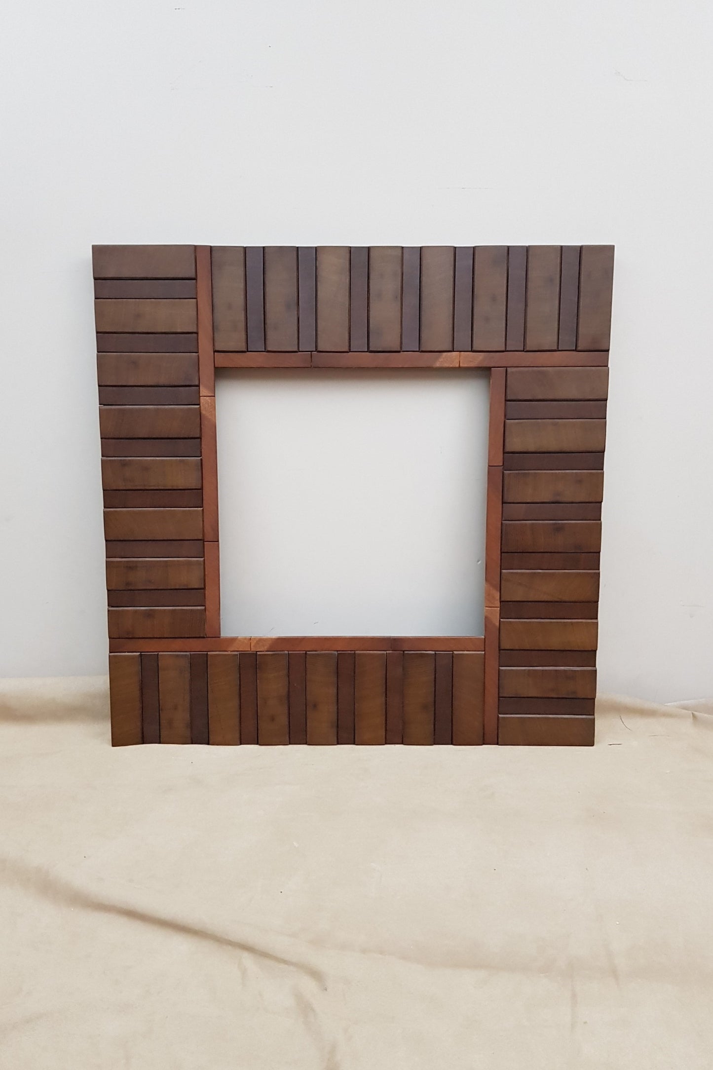 Square wooden mirror frame in end grain mahogany.