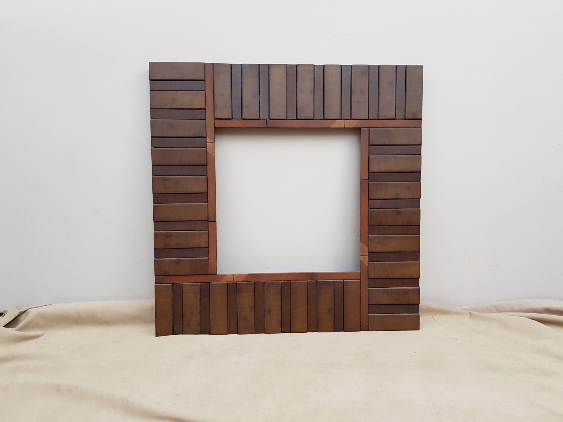 Square wooden mirror frame in end grain mahogany.
