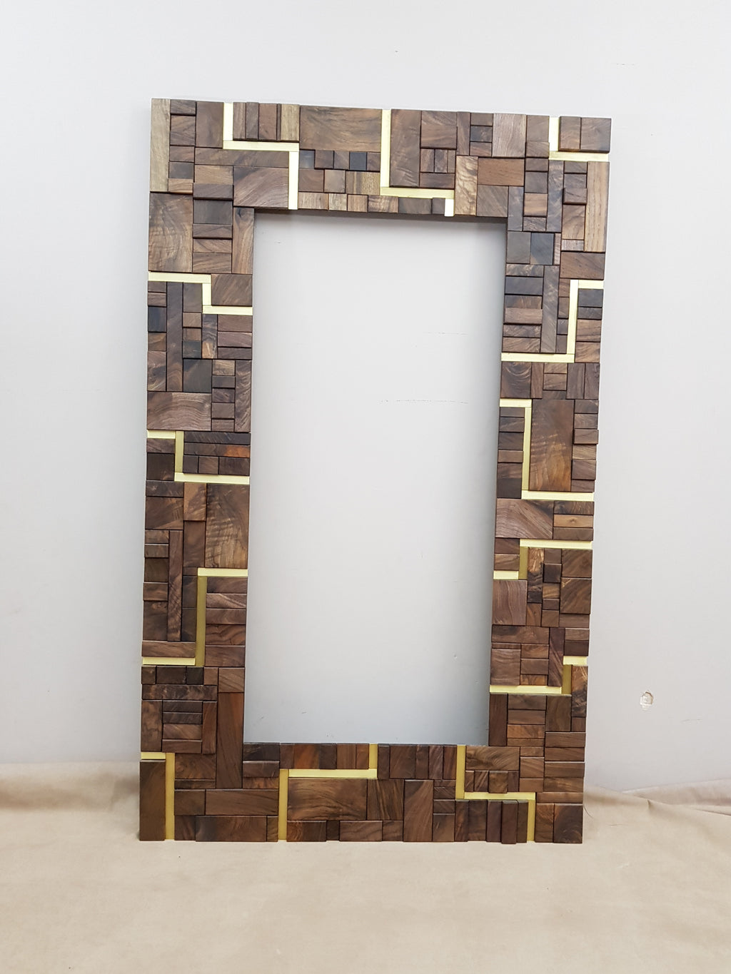 Large centrepiece statement mirror frame in figured walnut and brass