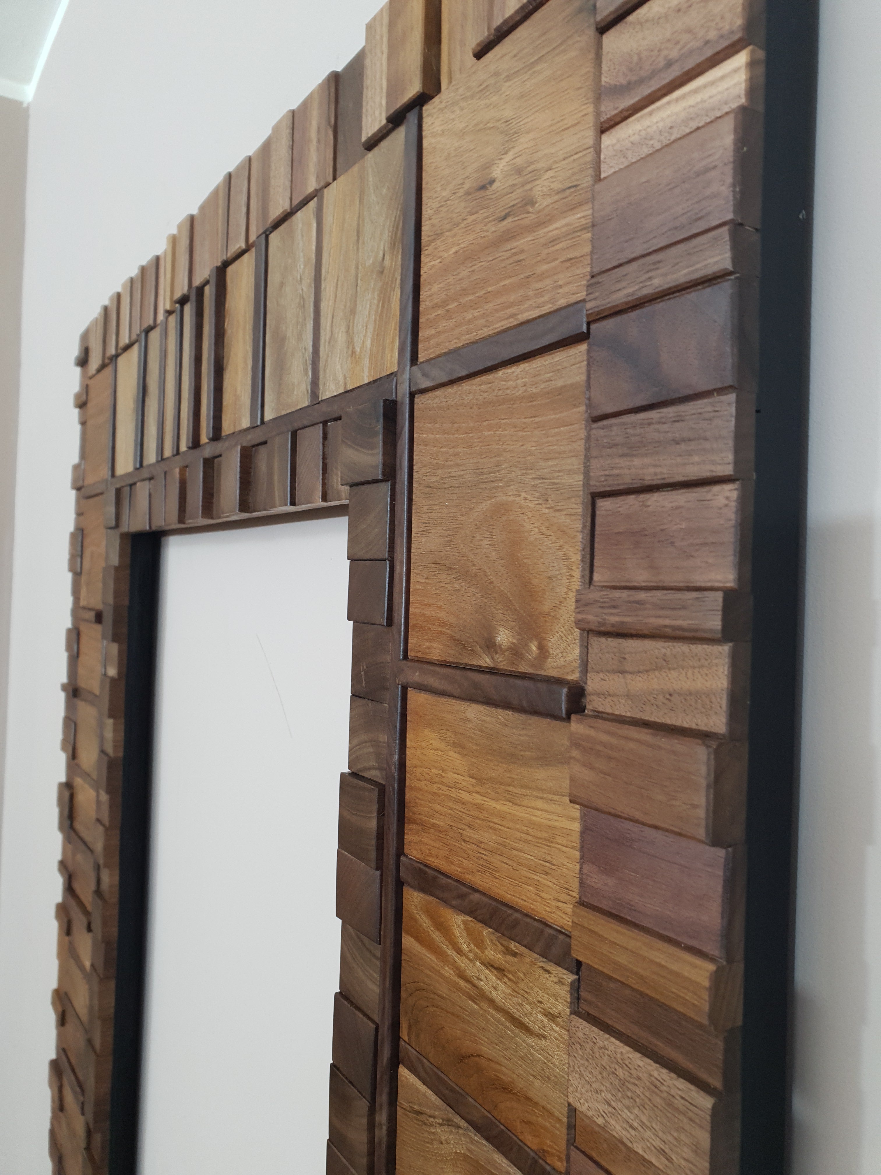 Large mirror frame in end grain mahogany.