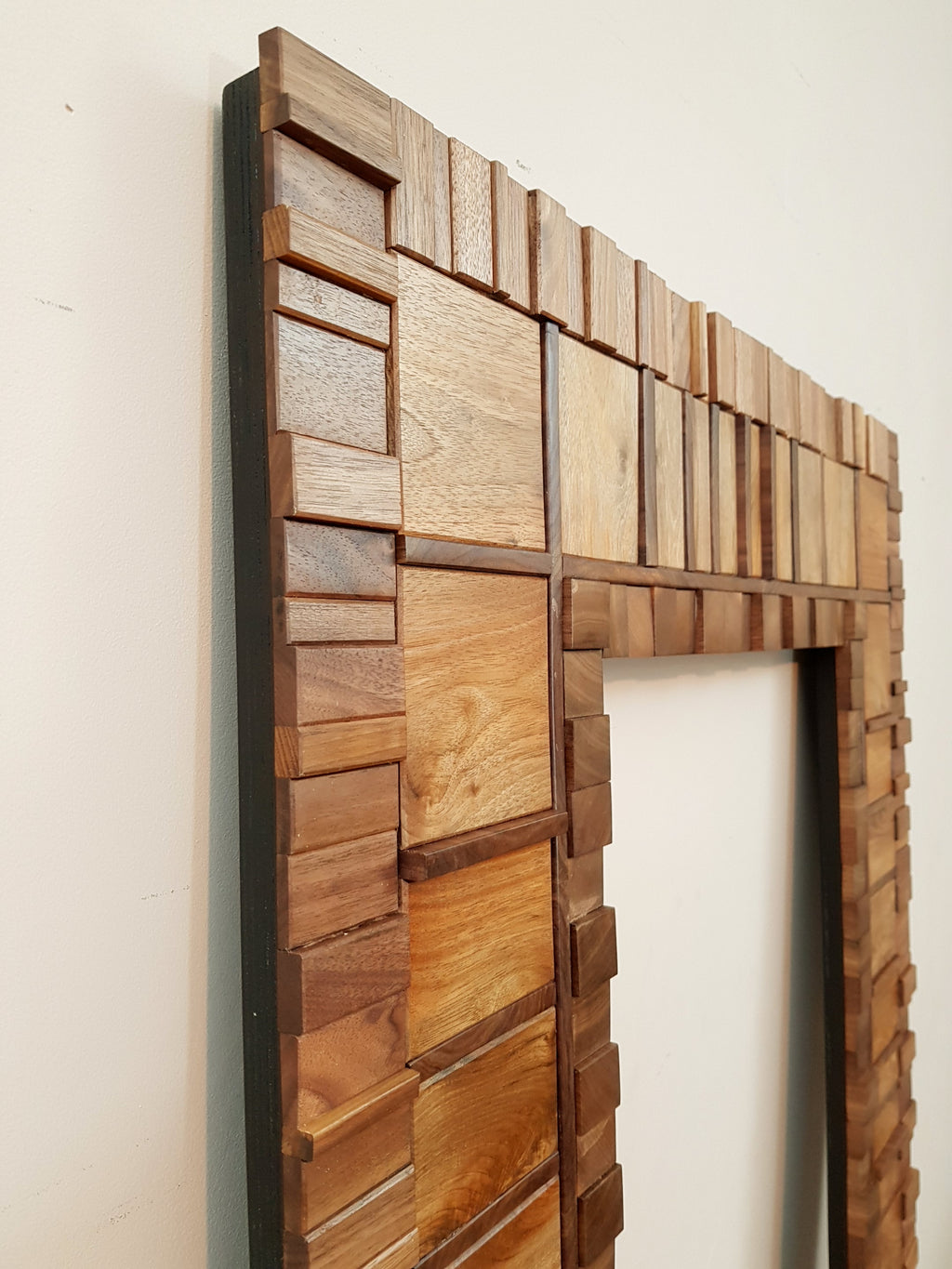 Large mirror frame in end grain mahogany.