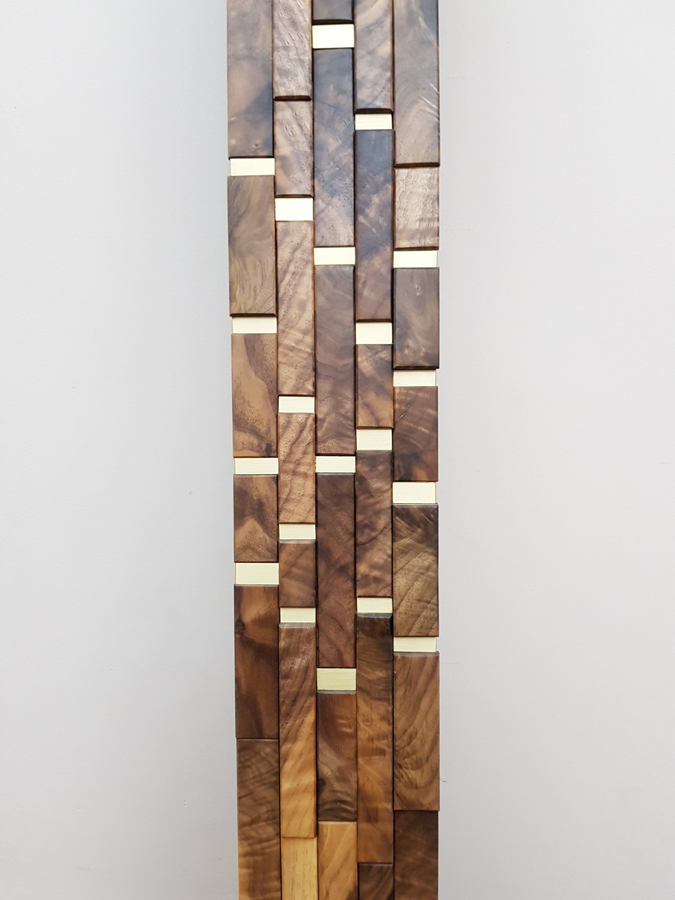 Modern centrepiece statement mirror frame in figured walnut and brass