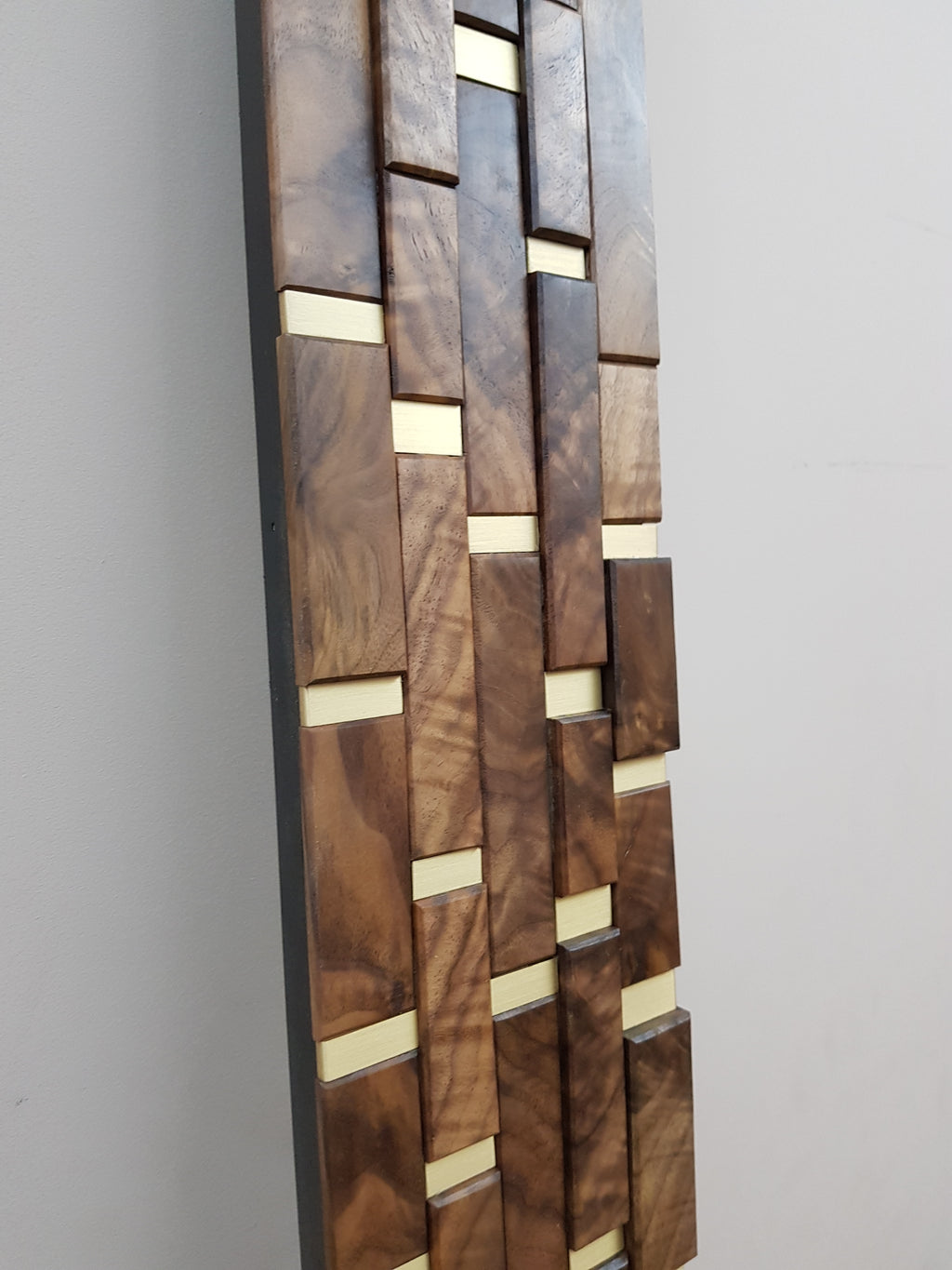 Modern centrepiece statement mirror frame in figured walnut and brass