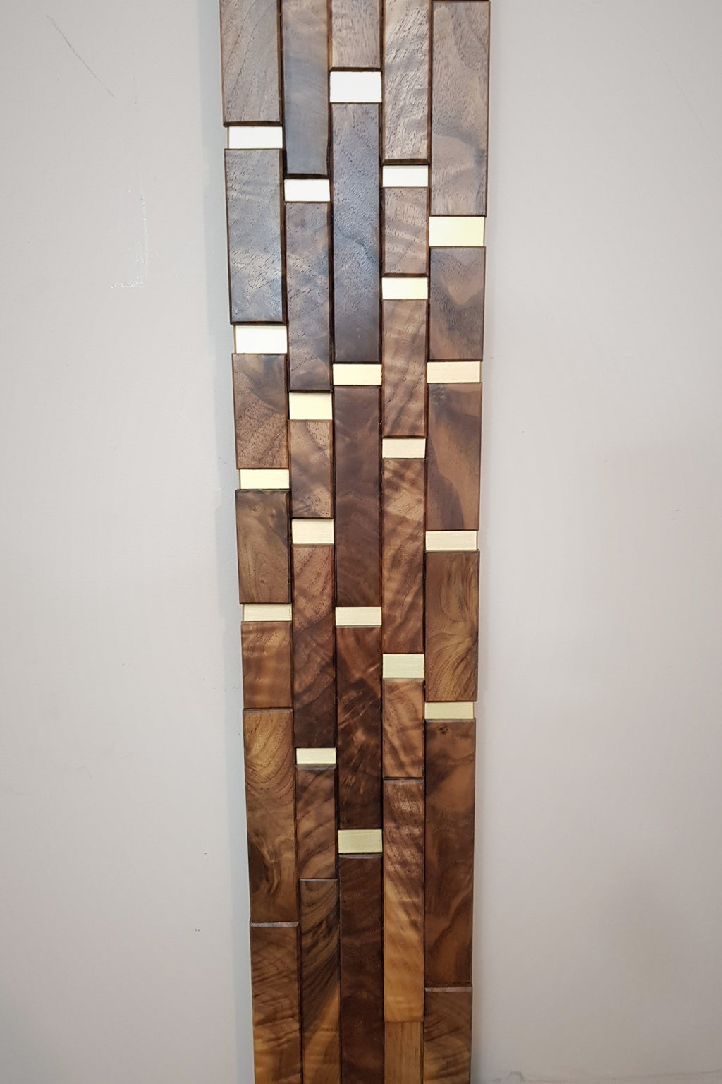 Modern centrepiece statement mirror frame in figured walnut and brass